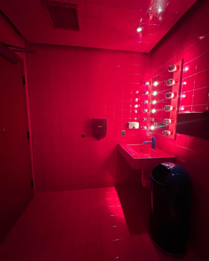 Vibrant Red Glam Bathroom with Hollywood Lights
