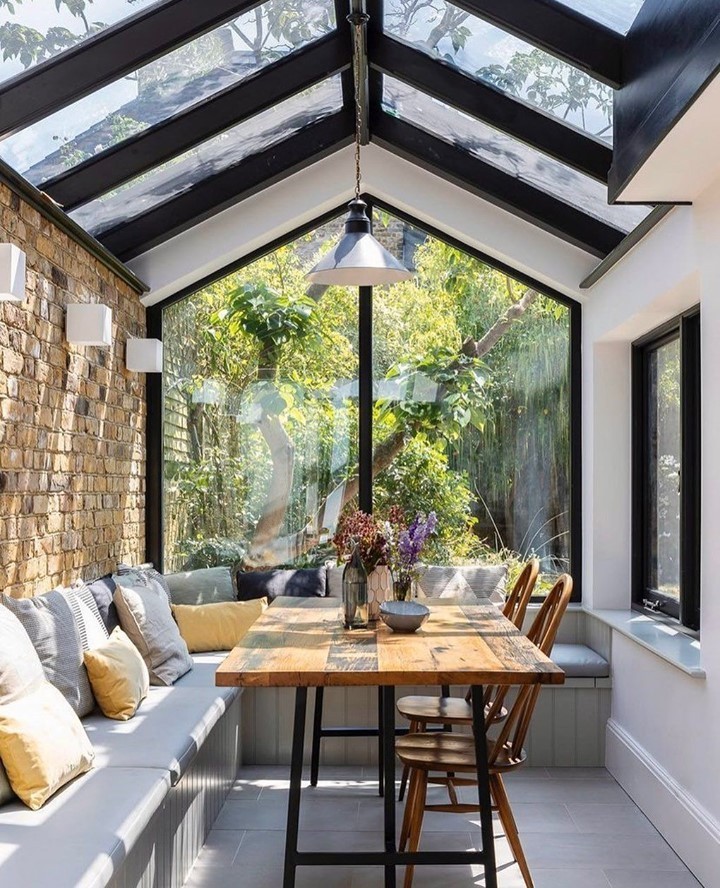 Bright Conservatory Dining Space with Garden Views

