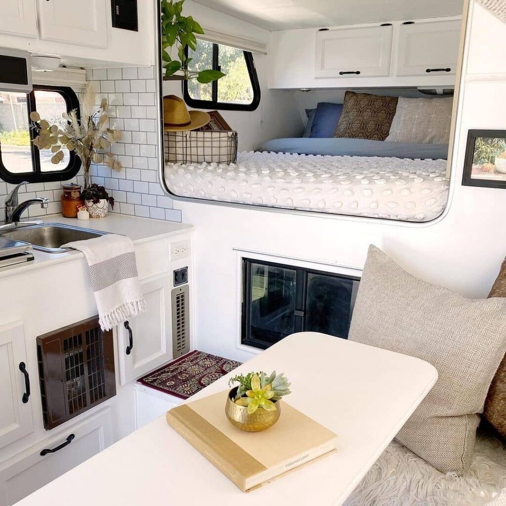 Bright and Efficient Small Camper Interior with Elevated Bed

