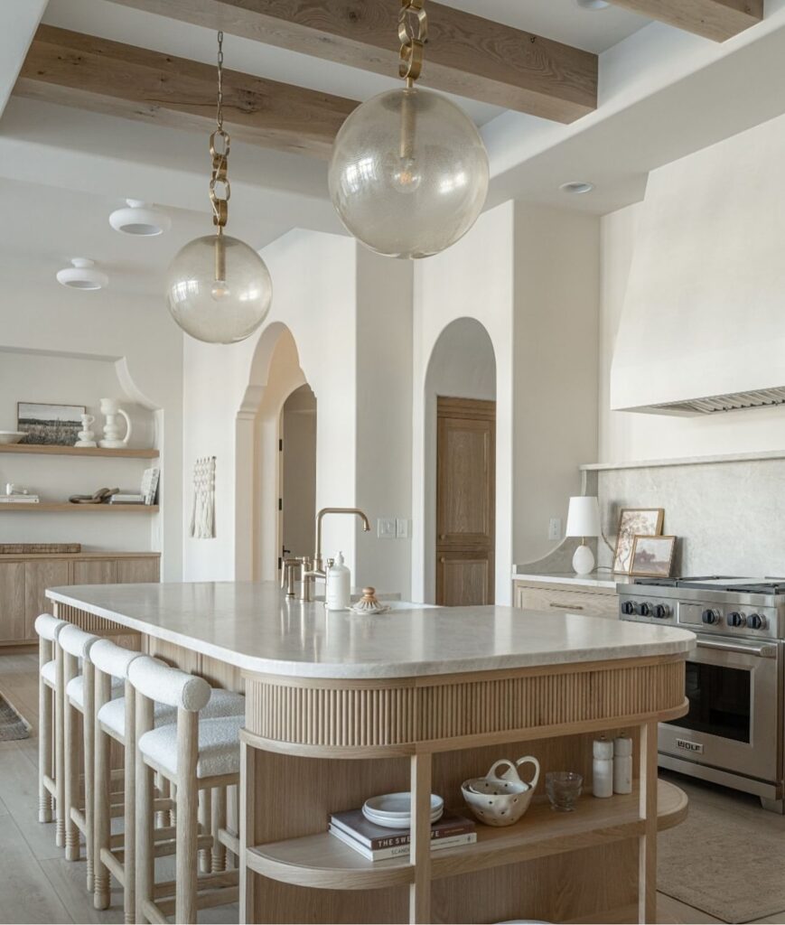 Bright and Modern Kitchen Island with Glass Pendants

