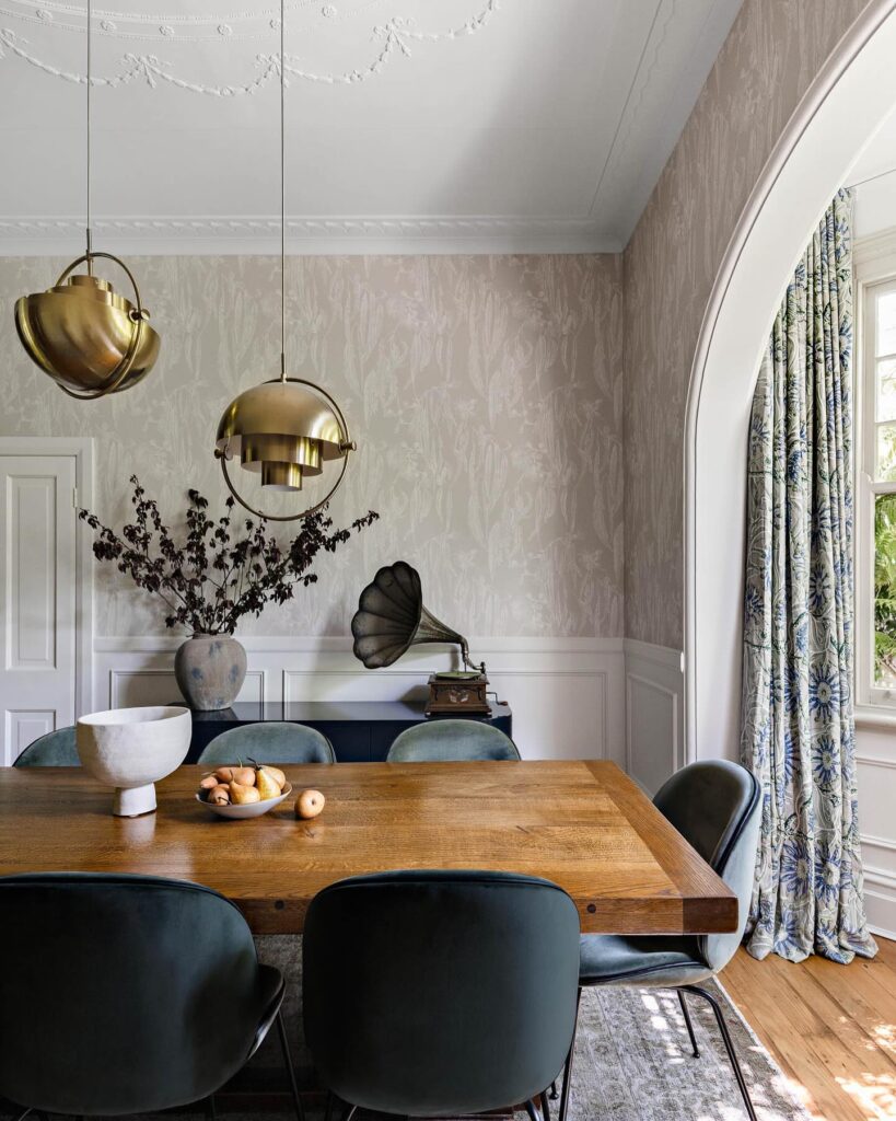 Elegant Dining Room with Vintage Accents and Modern Lighting

