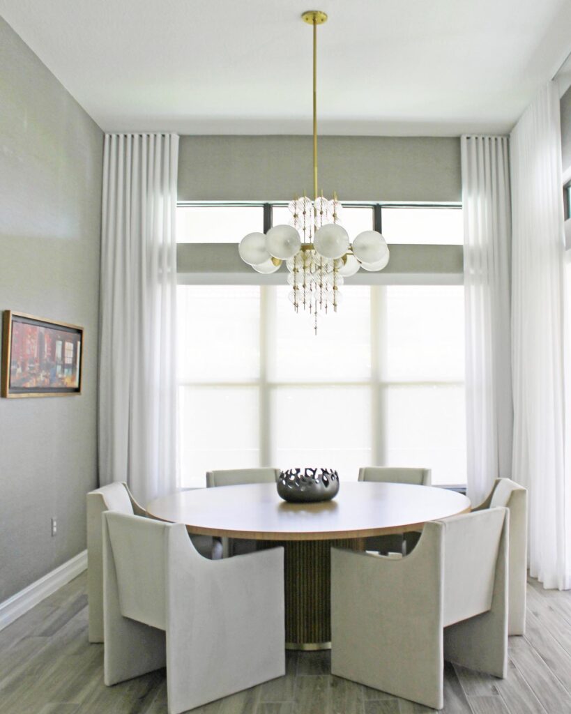 Elegant Modern Round Dining Area with Crystal Chandelier

