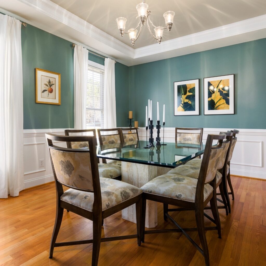 Elegant Teal Dining Room with Glass Table
