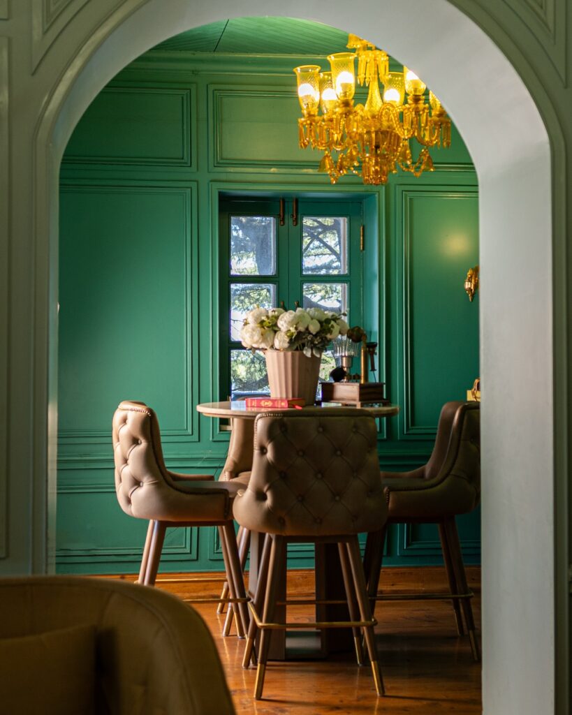 Intimate Green Dining Nook with Vintage Glamour

