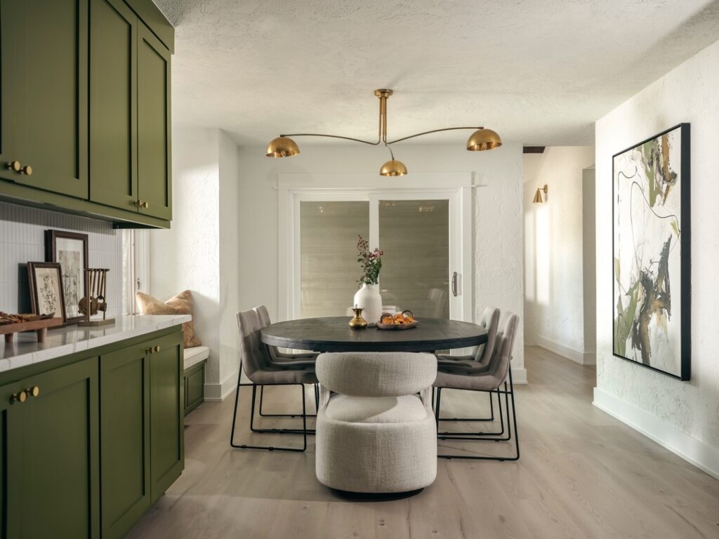 Modern Dining Nook with Green Cabinetry Accent

