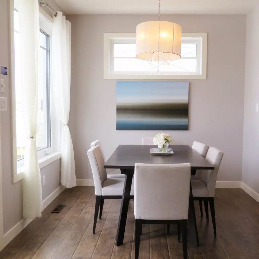 Serene and Modern Dining Nook with Landscape Art


