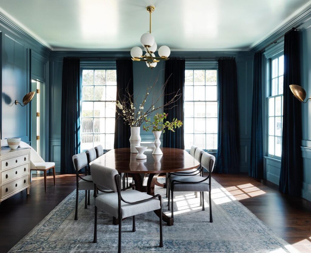 Sophisticated Teal Dining Room with Modern Lighting

