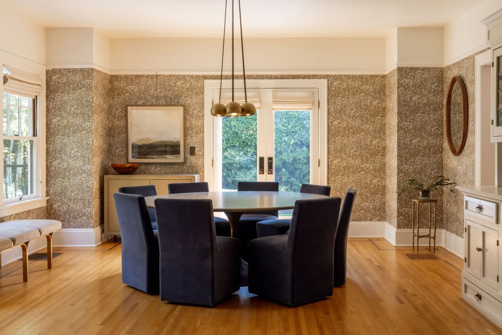 Warm and Inviting Dining Room with Patterned Wallpaper

