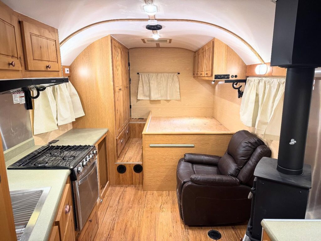 Well-Equipped Small Camper Interior with Wood Accents

