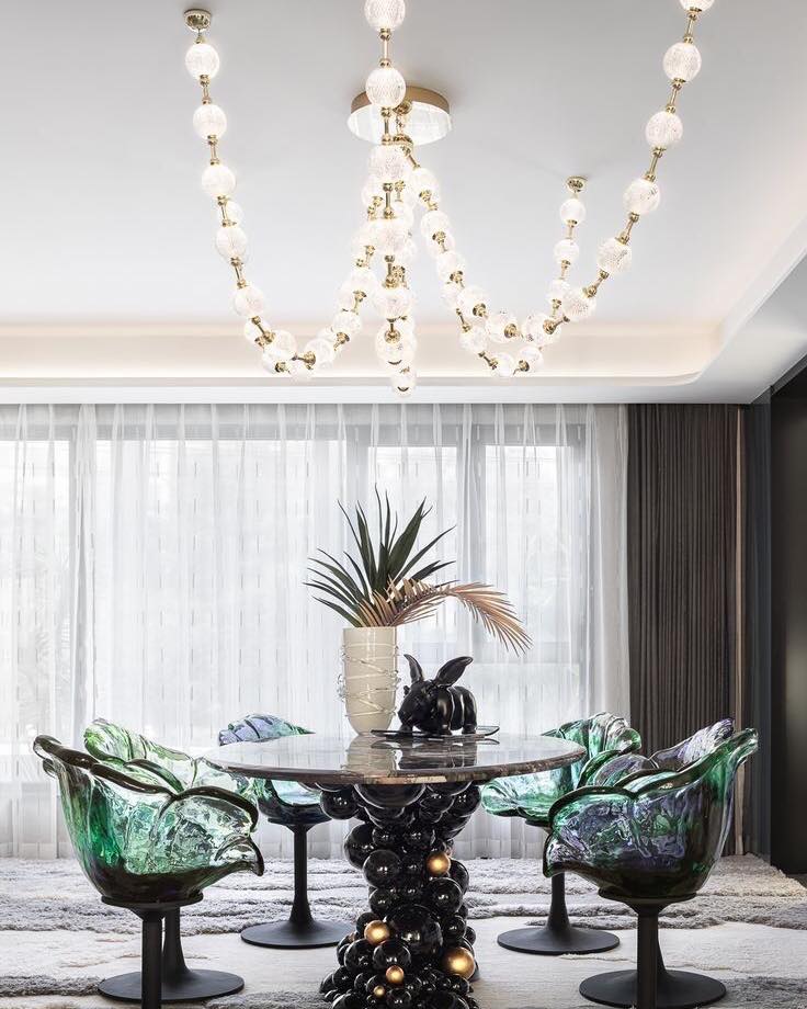 Whimsical and Modern Dining Area with Statement Chandelier

