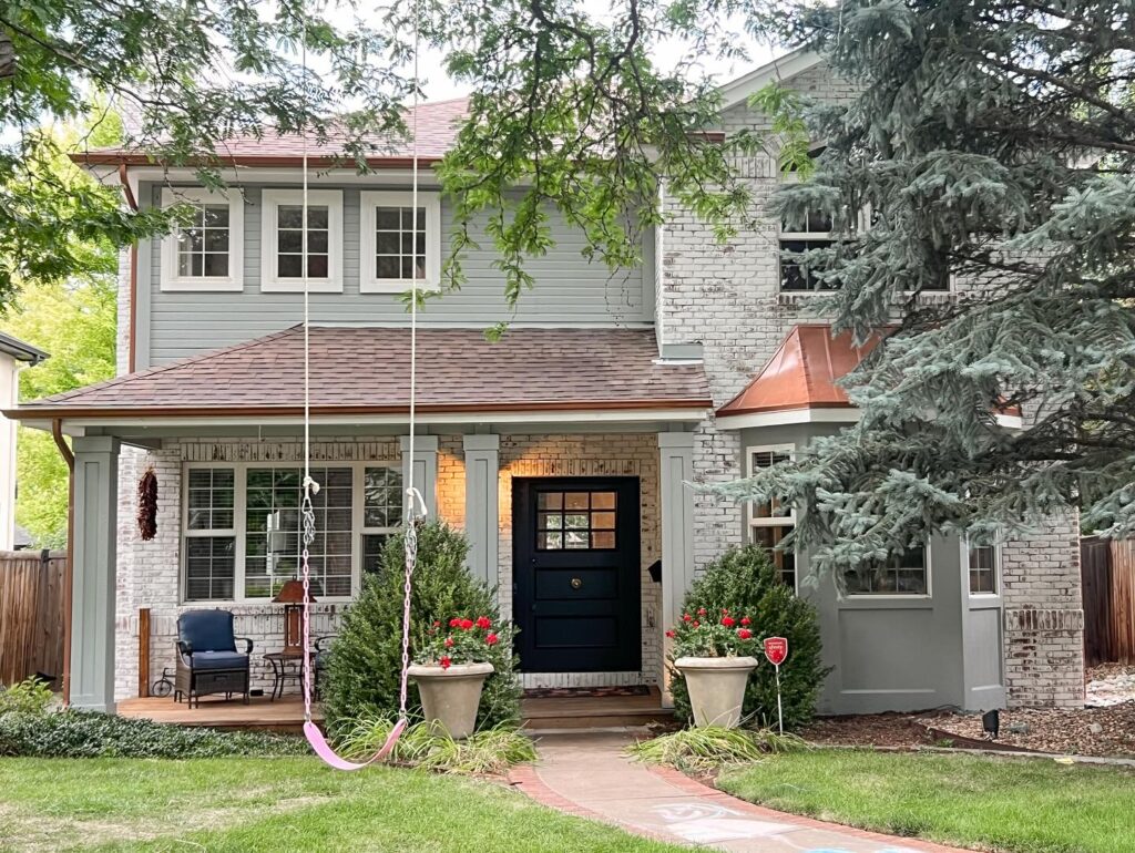Charming Two-Story Home with Whitewashed Brick and Dark Accents
