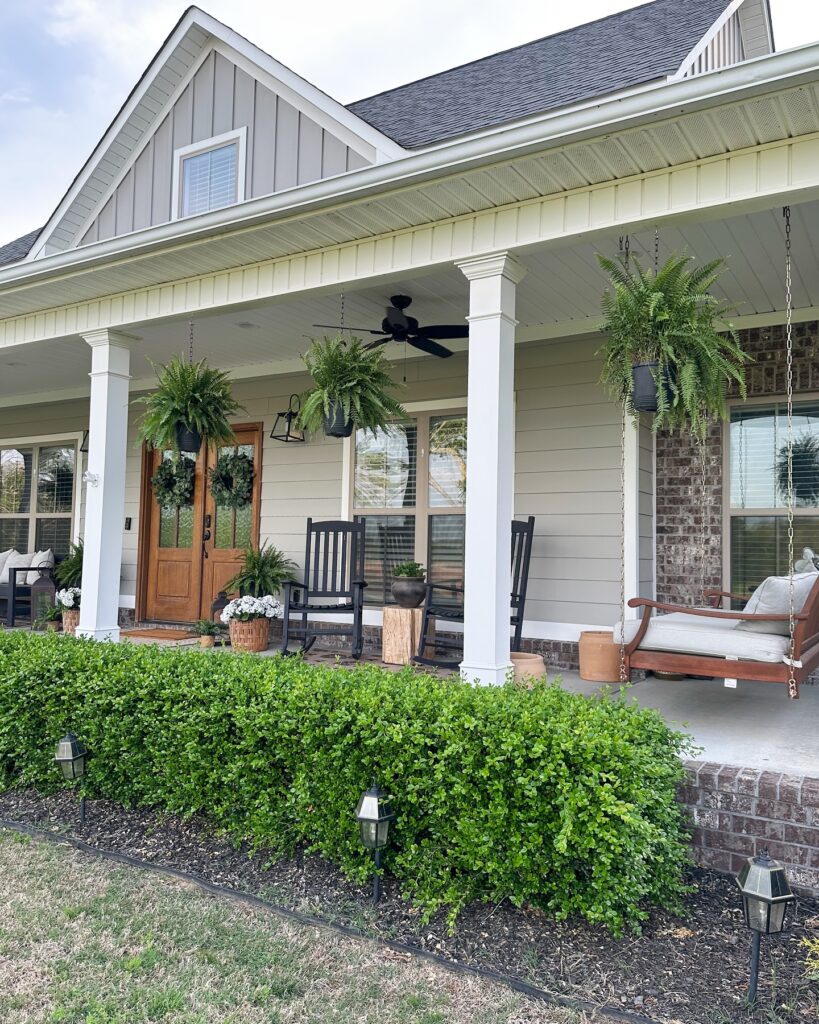 Inviting Southern Porch with Hanging Ferns
