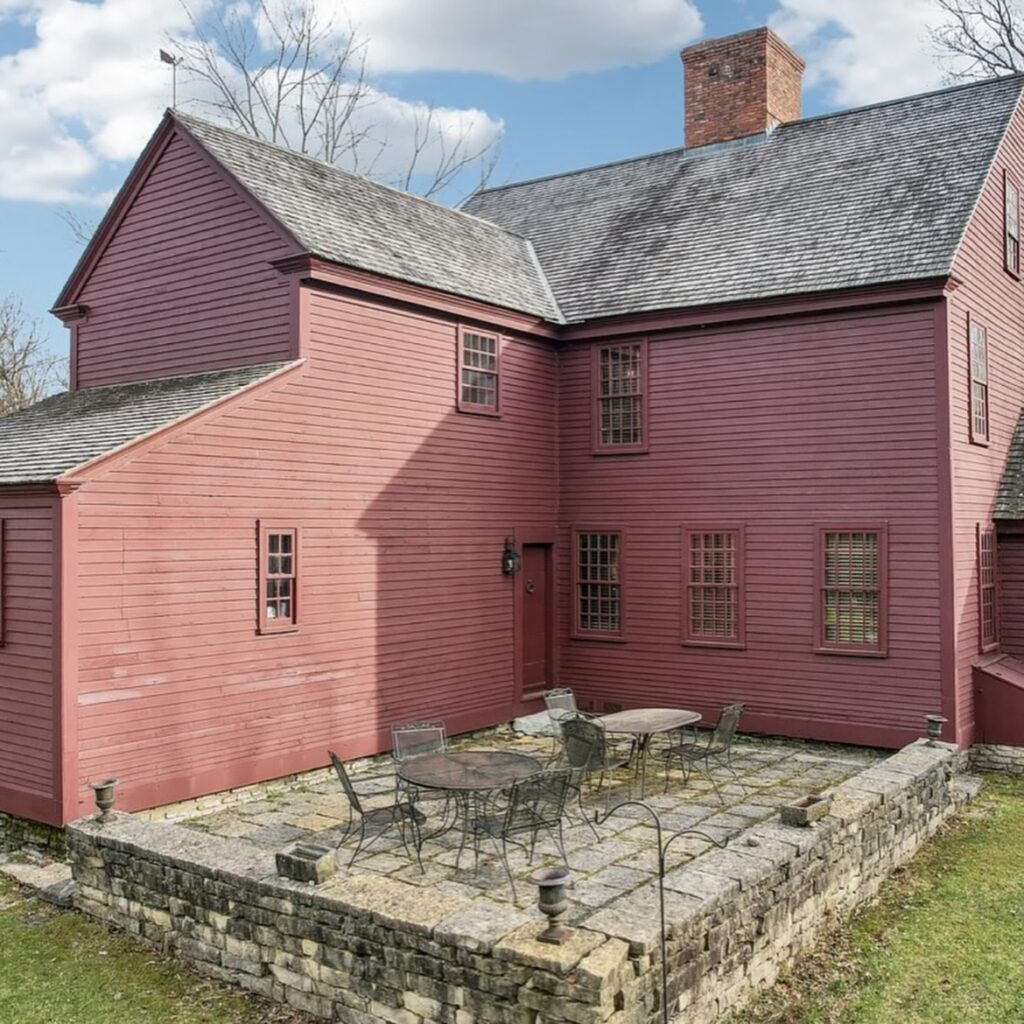 Red Brick House with Patio and Stone Wall
